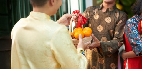 man giving basket ripe mandarins his senior dad when he is visiting lunar new year celebra copy v2